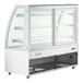 An Avantco white refrigerated bakery display case with curved glass shelves.