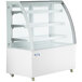 An Avantco white curved glass dry bakery display case with shelves.