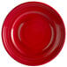 A red Tuxton Concentrix China plate with a circular spiral pattern.