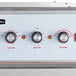 The control panel of a Cooking Performance Group SlowPro cook and hold oven with three knobs and a dial.
