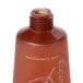 An Ecossential Naturals brown plastic bottle of shampoo with a leaf on it.