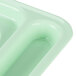 A close up of a Carlisle green polypropylene tray with 6 compartments.