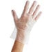 A person's hand wearing a clear Noble NexGen disposable TPE glove.