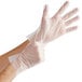 A person wearing medium-sized clear TPE disposable gloves.