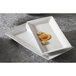 Two CAC Princesquare rectangular white porcelain platters with food on them.