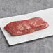 A Rastelli's 6 oz. Black Angus Coulotte Steak on white paper.