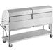A stainless steel Backyard Pro outdoor grill with two trays on wheels.