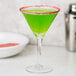 A green drink in a martini glass rimmed with Rokz watermelon sugar.