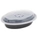 A black plastic Pactiv Newspring VERSAtainer oval container with a clear lid.