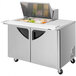 A stainless steel Turbo Air refrigerated sandwich prep table with food on top.