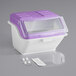 A purple and white plastic container with a clear lid and a scoop inside.