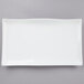 A white rectangular plate with a wavy edge.