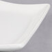 An American Metalcraft Wavy Stoneware Platter with a white background and curved edge.