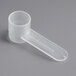 A clear plastic tube with a 2.5 cc polypropylene scoop on a gray surface.
