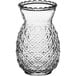 An Acopa clear glass with a pineapple pattern.