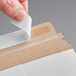 A person sealing a white Lavex Stayflats mailer with a piece of paper.