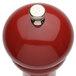 A Chef Specialties candy apple red pepper mill with a silver top.
