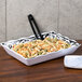 A black and white GET Soho melamine tray with a dish of pasta on a table.