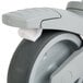 A close up of a gray wheel with a white rim for a Cambro shelving caster.