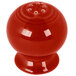A red Fiesta pepper shaker with holes.