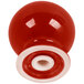 A white ceramic pepper shaker with a red knob.