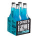 A cardboard case with six bottles of Jones Berry Lemonade Soda. Each bottle has a blue label.