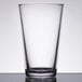 A close-up of a clear Libbey beverage glass on a table.