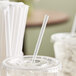 A Dixie plastic cup with a clear straw in it.