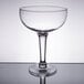 A clear Libbey Super Margarita Glass with a stem on a table.