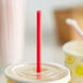 A red Dixie Giant straw in a plastic cup.