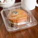 A muffin in a Durable Packaging clear hinged plastic container.