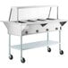 A ServIt open well stainless steel electric steam table warmer on wheels.