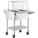 A ServIt stainless steel electric steam table with an angled glass sneeze guard and tray slide.