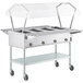 A ServIt electric commercial steam table food warmer with a clear cover on wheels.