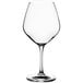 An Acopa Radiance burgundy wine glass with a stem on a white background.