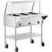 A ServIt stainless steel open well electric steam table on wheels.