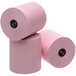 A group of pink Point Plus cash register paper rolls.