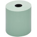 A close-up of a roll of green Point Plus thermal paper with a hole in the middle.