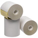 A group of Point Plus 2-ply carbonless paper rolls on a white surface.