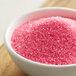 A bowl of Regal pink sanding sugar.