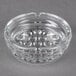 A clear glass Libbey Nob Hill ashtray with holes in it.