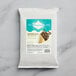 A package of Creamery Ave. Espresso Soft Serve Mix with coffee beans on a marble surface.
