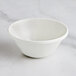 A RAK Porcelain ivory bowl on a marble surface.