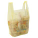 A yellow 1/6 size medium-duty plastic T-shirt bag filled with food.