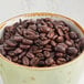 A bowl of Crown Beverages Royal Reserve Sumatra Decaf whole bean coffee.