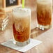 A glass of Crown Beverages Royal Reserve decaf coffee with a straw.