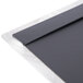 A close-up of a black and silver metal surface on a Menu Solutions Alumitique menu board.