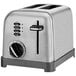 A silver toaster with a black dial and buttons.