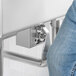 A person using a Regency wall mount handsink faucet with a knee valve.