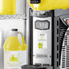 A machine with a yellow container of Narvon Dew Drop Slushy concentrate next to it.